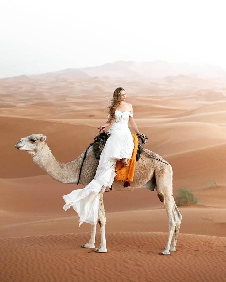 Sahara Majestic Luxury Camp Hotel Мерцуга Екстериор снимка A woman riding a camel in the desert